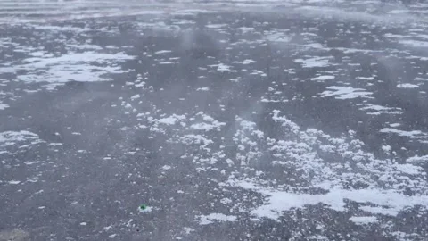 Close view over snow drift on asphalt road, blizzard, cold winter in the city Stock Footage 171100543