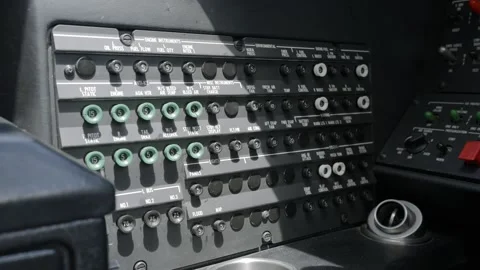 Close up view of overhead panel of aircraft cockpit with various switches, knobs Stock Footage 276374286