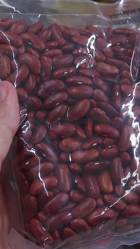 Close-up view of packaged dry red beans held in hand Stock Footage 336663299