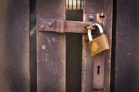 Close up view of a padlock and old wooden door Stock Photos