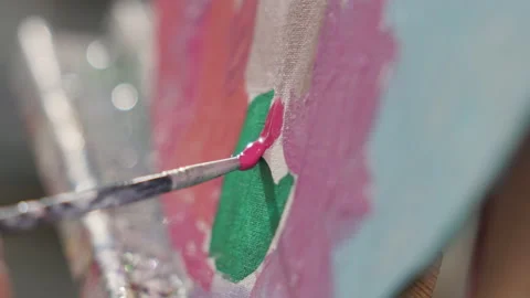 Close up view of paintbrush. Girls hand draws on canvas with pink acrylic paint Stock Footage 228779341