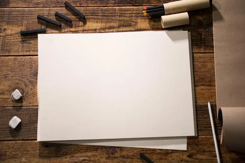 Close-up view of a painter on a white sheet. A man holds a pencil and draws.  Stock Photos