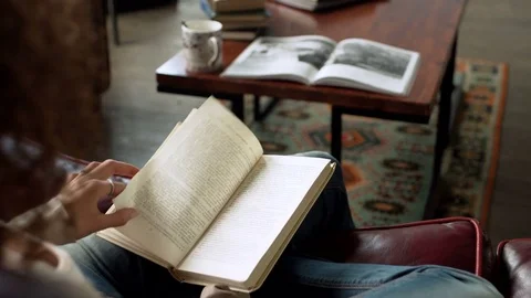 Close up view of paper book in hands of latin young woman who read it, sitting Stock Footage 73871443
