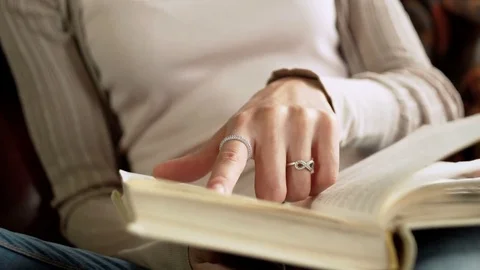 Close up view of paper book in hands of latin young woman who read it, sitting Vídeos de archivo 73872807
