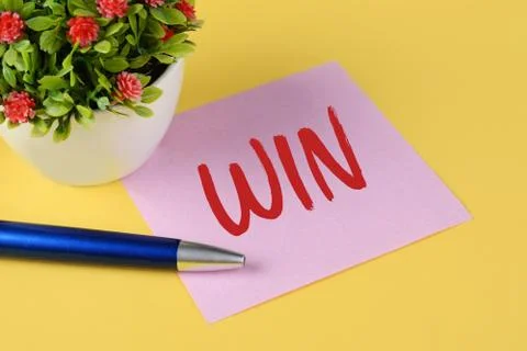 Close up view of paper note with text "Win" Stock Photos