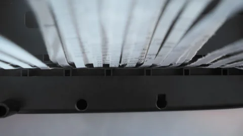 Close up view of a paper shredder cutting a sheet of office paper, document into Stock Footage 297086822