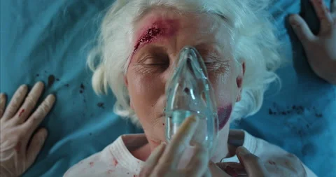 Close up view of paramedics checking pulse and puttng on injured old lady oxygen Video stock 141503078