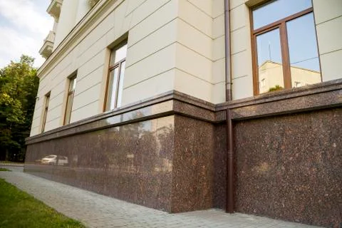 Close up view of part of a building facade with the surface of granite wall.  Fotos de archivo