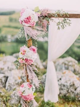 Close-up view of the part of the wedding arch decorated with flowers and herbs. Stock Photos