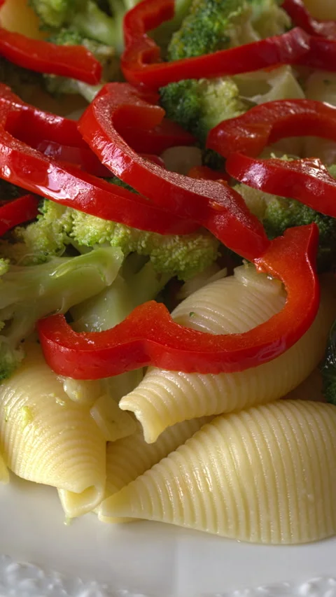 Close-up view of pasta with broccoli and red pepper. Vertical video. Stock Footage 280107496