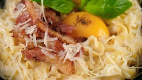 Close-up view of Pasta Carbonara, topped with egg yolk Stock Footage 80708039
