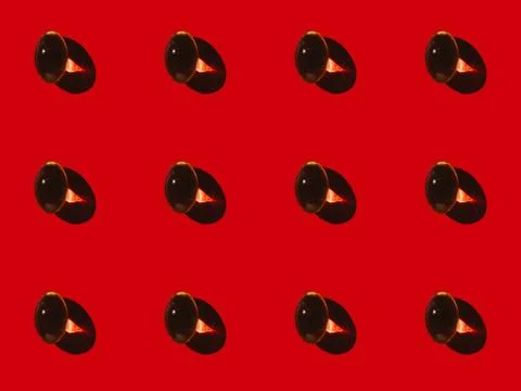 Close-up view of pattern made from shiny capsules on red Stock Photos