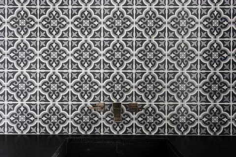 Close-Up View Of Patterned Black And White Tiles And A Black Countertop Sink. Stock Photos