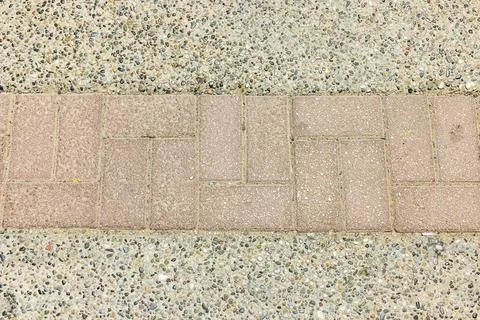 Close up view of pavement texture with brick line and concrete surface pattern. Stock Photos