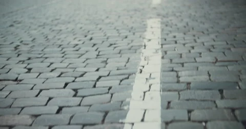 Close up view of pavin slabs with road marking under the feet of operator Stock Footage 151671210