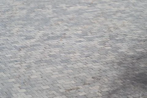 A close view of paving stones forms an intricate pattern, blending shades of  Stock Photos