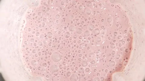 Close-up view of peach-colored smoothie with creamy texture and small bubbl.. Stock Footage 315033464