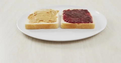 Close up view of peanut butter and jelly sandwich on wooden surface Stockbeeldmateriaal 191097139