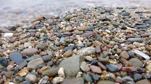 Close-up view of the pebbles and waves at the beach fast forwarded 스톡 동영상 48899477