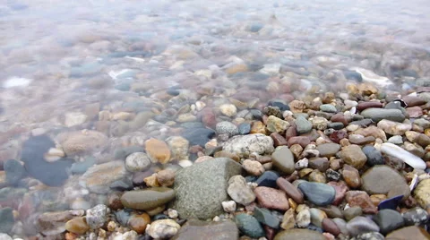 Close-up view of the pebbles and waves at the beach Video stock 48899637