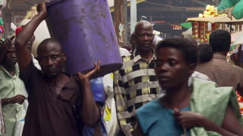 Close view of pedestrians passing camera on a crowded street in Kampala, Uganda Stock Footage 59531223