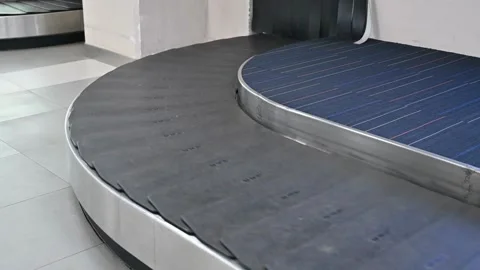 Close-up view of people receiving baggage from baggage carousel in Miami ai.. Video stock 256746289