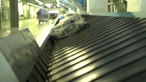 Close-up view of people receiving baggage from baggage carousel in Miami ai.. Stock Footage 256748525
