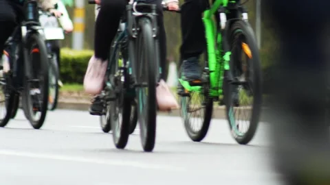 Close up view of people riding bicycles on a street with motion blur, Stock Footage 339865349