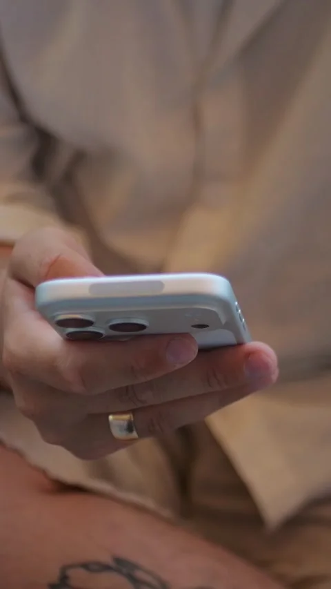 Close-Up View of Person Browsing on Smartphone While Sitting... Stock Footage 344455290