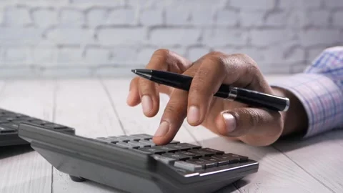 Close up view of person hand using calculator for finance and business calc.. Stock Footage 332626436