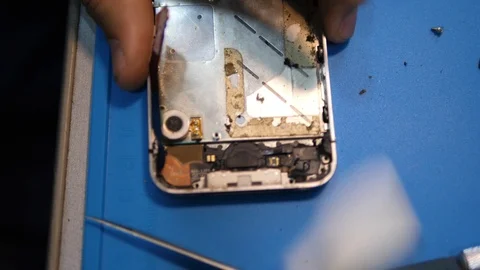 Close view person hands clean iphone from glue and dirt Stock Footage 104654989