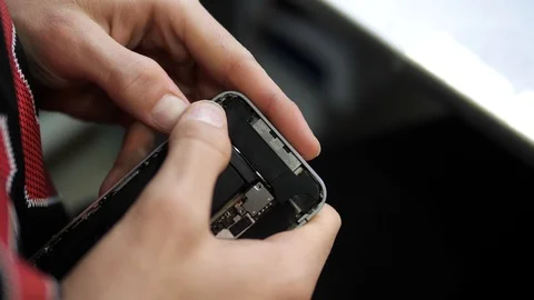 Close view person hands fix storage battery in iphone Stock Footage 104655237
