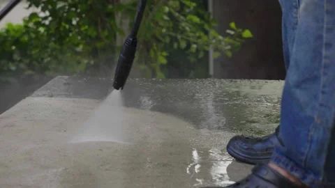 Close up view person with high pressure jet gun stop spraying water to ground Stock Footage 157007329