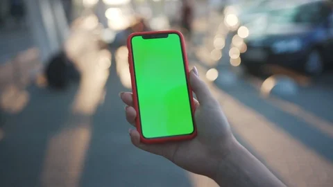 Close-up view of person holding a smartphone swiping pages on mockup greenscreen Stock Footage 112059253