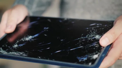 Close up view of person holding tablet computer with heavily cracked and sh.. Stock Footage 334764330