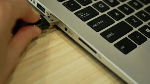 Close-up view of a person inserting a pendrive into the usb port at laptop. 動画素材 145181795