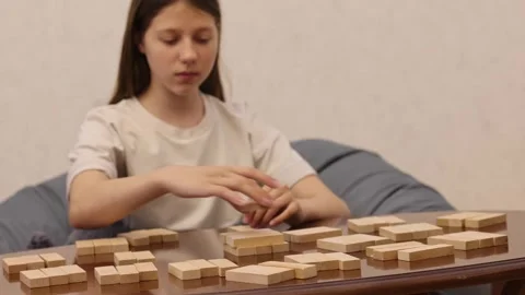 Close-up view of a person playing chess on a wooden board, moving a pawn forward Stock Footage 278885855