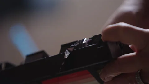 Close-Up View Of A Person Rewinding Loose Tape Of A VCR Cassette Vidéo 337042553