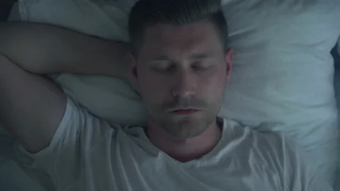 Close-up view of a person slowly wakes up early in the morning Stock Footage 218437896