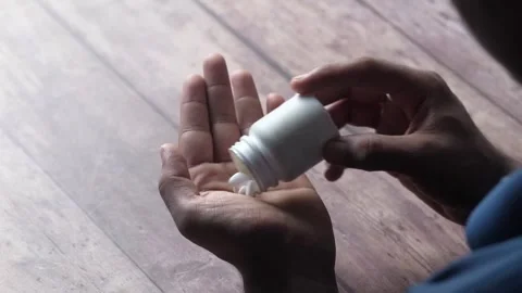 A close up view of person taking a lot of pills on hand, slow motion video .. Stock-Footage 333030064