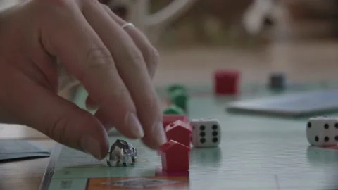Close up view of a person throwing the dices in a monopoly game. Filmed Stock Footage 158289337