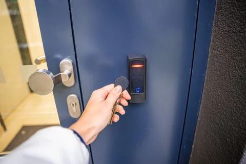 Close up view of person using a electric lock key fob to access a building via a Stock Photos