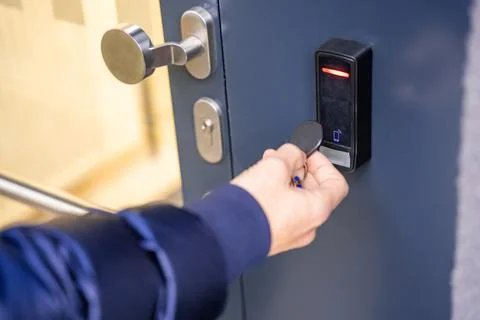 Close up view of person using a electric lock key fob to access a building via a Foto stock
