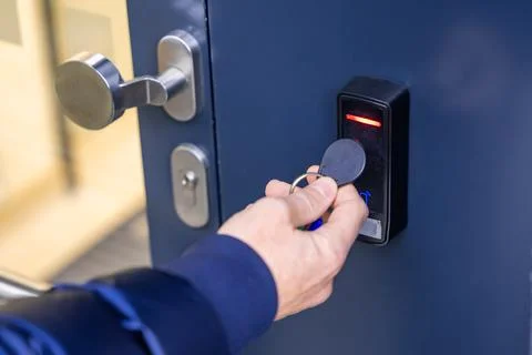 Close up view of person using a electric lock key fob to access a building .. Stock Photos
