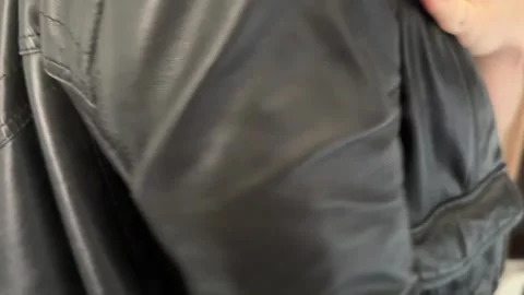 Close view of person wearing leather pants showing clothing material Stock Footage 336976617