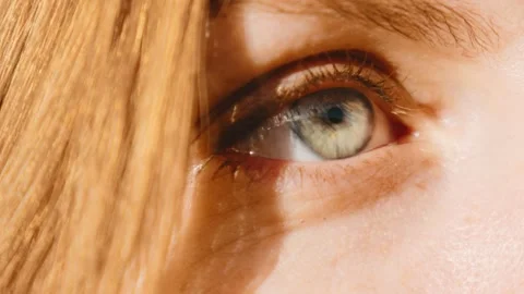 Close view of a person's eye in bright light showing details of iris and eyelash Stock Footage 343842729