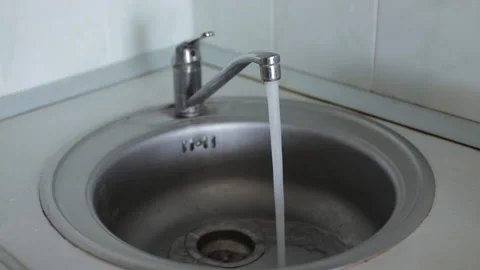Close up view of a person's hand turning on a modern chrome faucet. Stock Footage 327159075