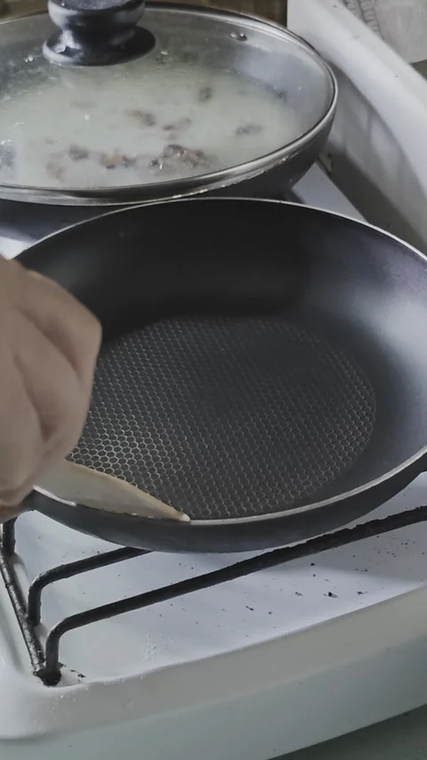 Close up view of a person's hand using a wooden spatula to place a piece 스톡 동영상 342610837