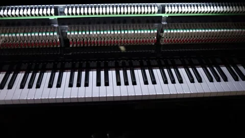 A close-up view of a piano keyboard and its intricate hammer mechanism, showcase Stock Footage 294706537
