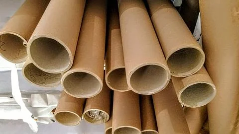 Close-up view of a pile of empty brown cardboard tubes hanging downwards. Stock Photos